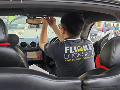 Locksmith working inside a car