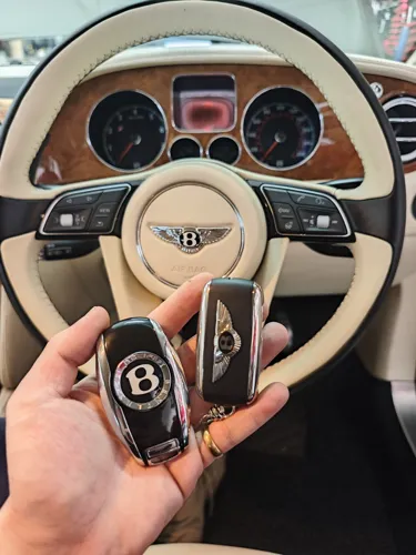 Car keys in front of a steering wheel