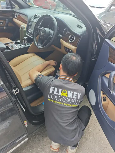 Locksmith working inside a car